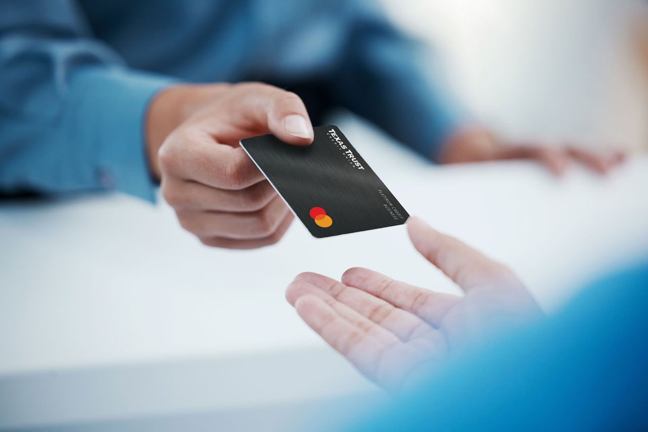Corporate hands exchange credit card to accountant for payment for company tax bills, money loan and accounting fees. Businessman with banking card to invest in financial savings budget investment.