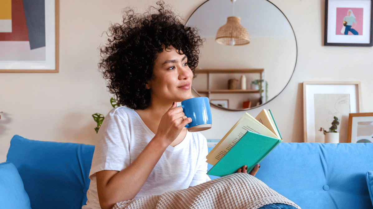 Woman enjoying a book on the couch
