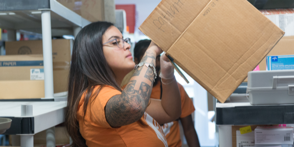 Young lady sorting through boxes 