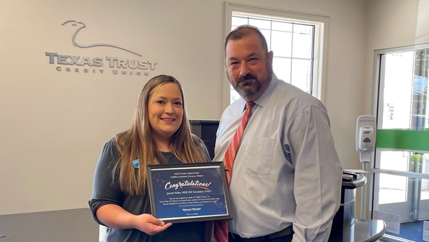 Texas Trust's Kaitlin Lange (left) presents HED ISD's Jayson Wiles (right) with Golden Gratitude Giveaway award.