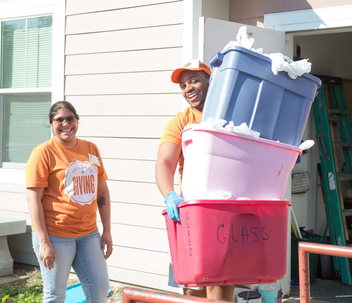 man and woman moving plastic containers