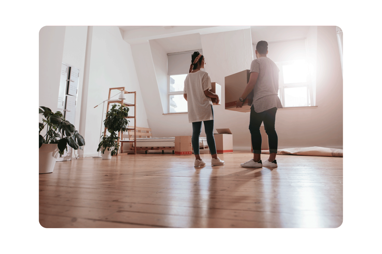 Real estate agent giving keys to couple of customers. Happy young couple getting keys of their new home. Real estate agent giving a key from new house to young couple